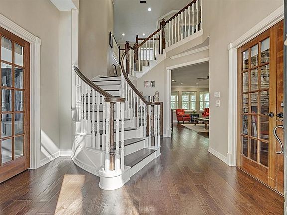 As you enter the property you are greeted with soaring ceilings and a beautiful dual sided staircase. To the left and right you have mirrored french doors for both home offices.