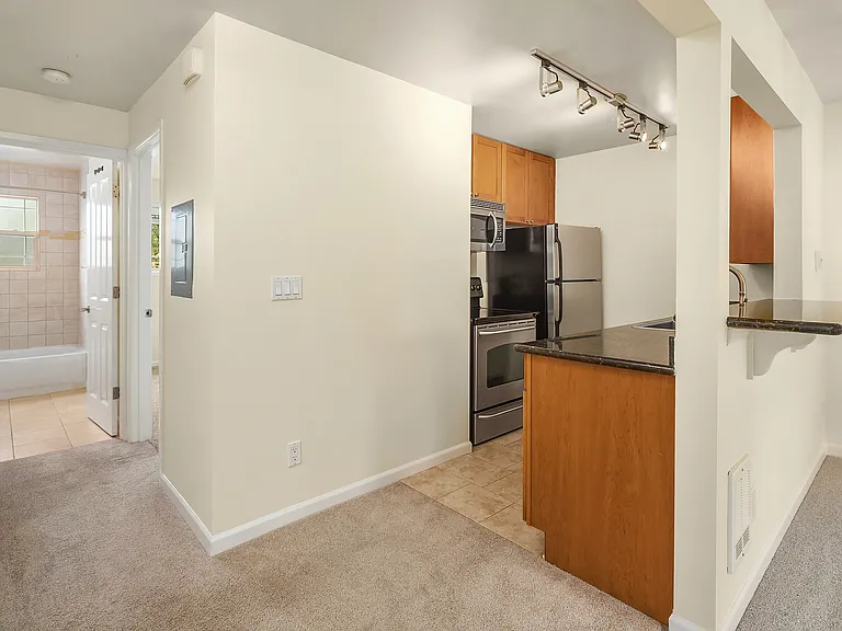 From dining area, looking into kitchen, with bed/bath hall to the left and LR to the right.