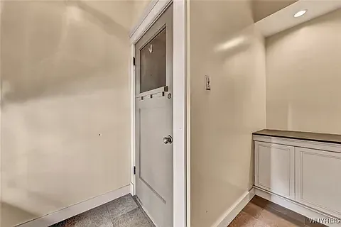 Entrance foyer with steps to the huge private upper landing/ mudroom, closet. Mail is securely delivered to the home through mail slot. There is a shared mail/ message center/ counter space, and large area for package storage.