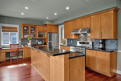 Kitchen with ooldes of storage, honed granite countertops + gas cooking.