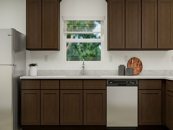 The kitchen has sprawling granite countertops and a wonderful window.