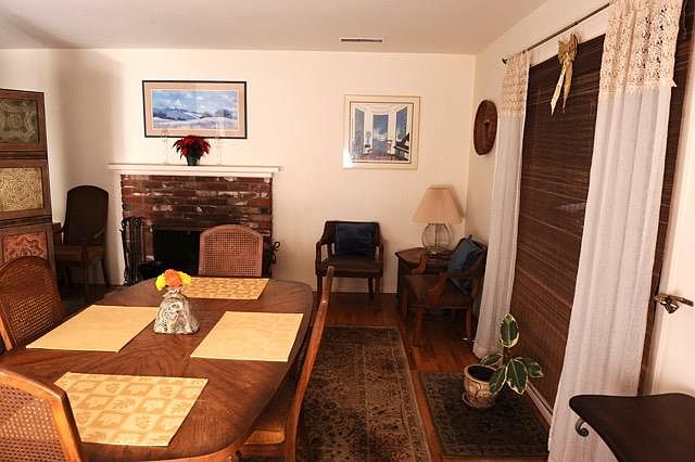Living/dining room w/wood burning fireplace.