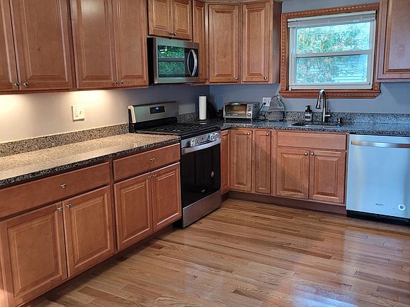 Fully applianced kitchen with under-the-cabinet lighting