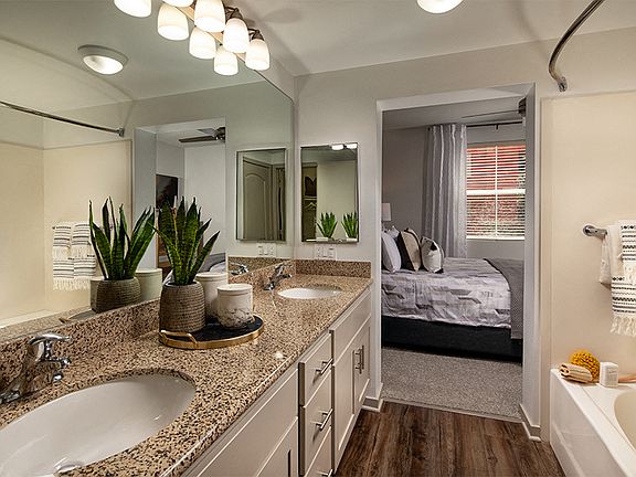 Bathrooms feature soaking bathtubs, granite countertops and luxury vinyl plank flooring