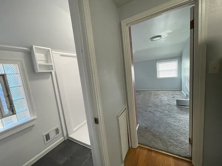 View into 1st bedroom opening from hallway after bathroom