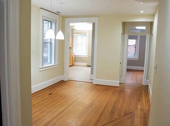 Dining room and entrance looking into kitchen and bath towards balcony