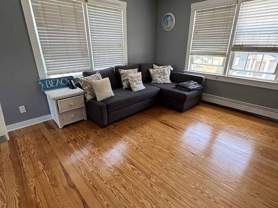 Living room with a couch that converts into a bed.