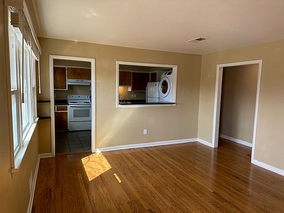 View of kitchen and doorway to bathroom and bedrooms from just inside front door