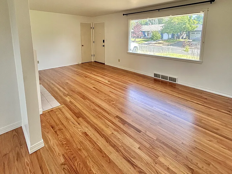 Living room looking toward front door - floors refinished July 2026