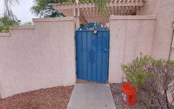 Steel security gate leading to private patio area