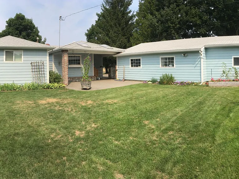 The back yard, with the house on the left and the garage and shop on the right. The shop is reserved for landlord's storage, but the garage is very large.