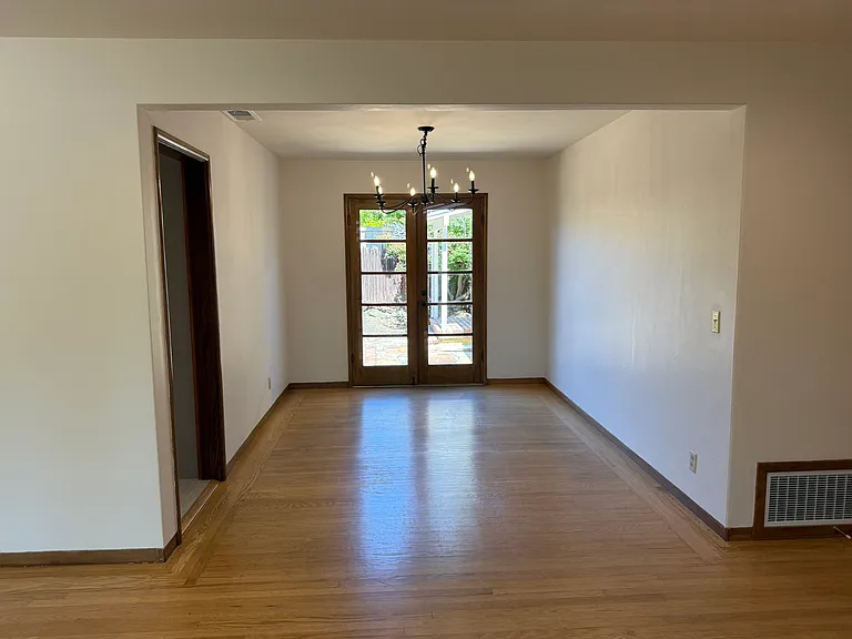 Formal dining room with hardwood flooring throughout and a patio door that flows to a relaxing backyard.