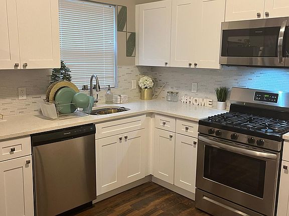 Modern Kitchen with Quartz Countertops and Mosaic Backsplash