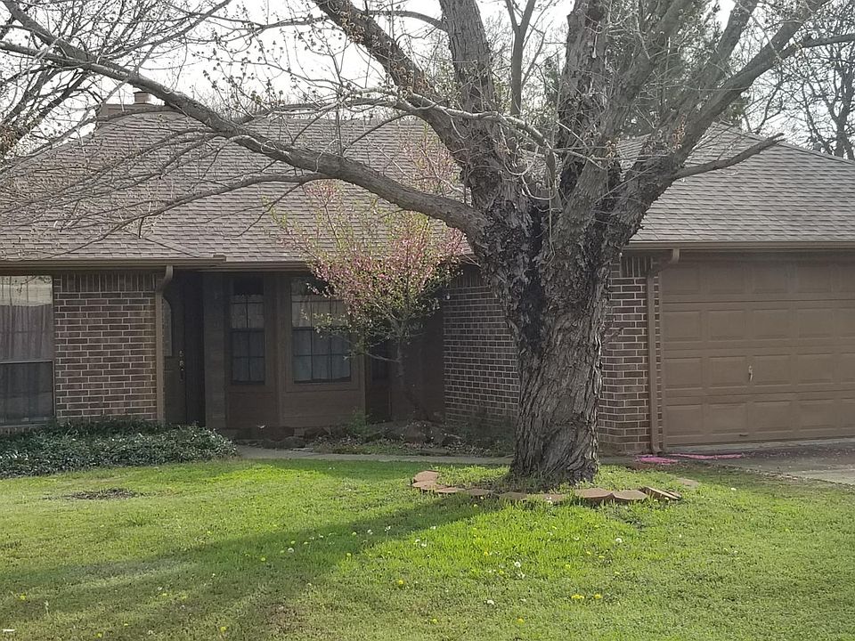 Front yard view with porch , two car garage and bay window.