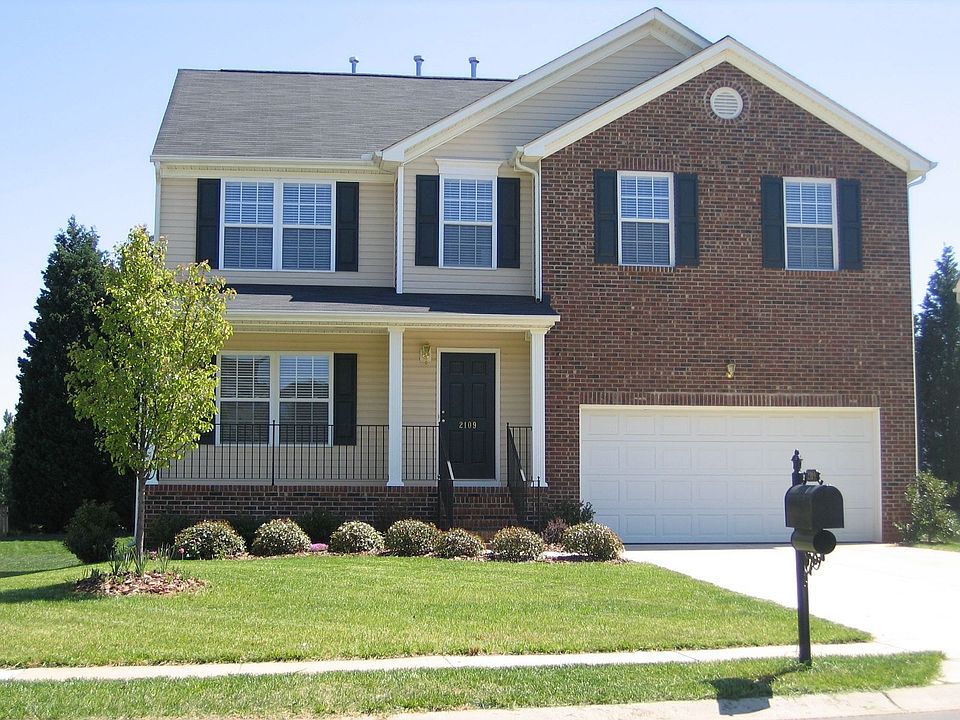 Partial brick front with rocking chair front porch