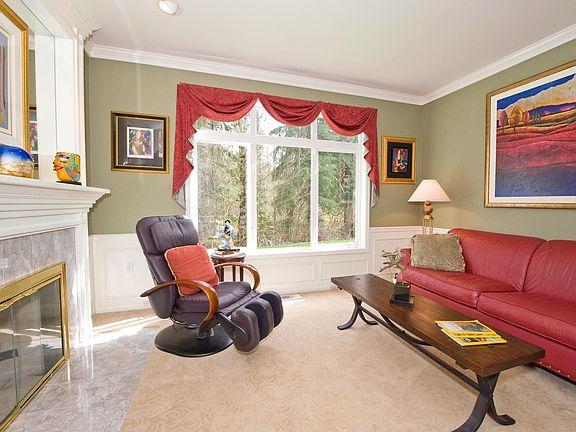 The formal living room with fireplace and oversized window