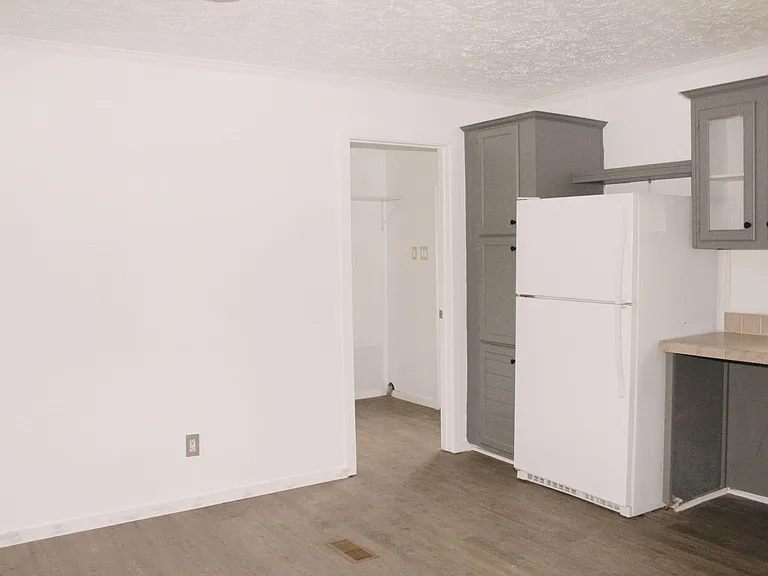 Kitchen and dining room area looking into the utility room and backdoor
