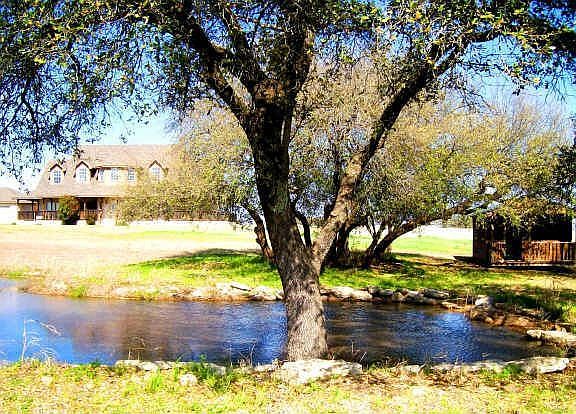 Pond and Home with Rustic Cabin