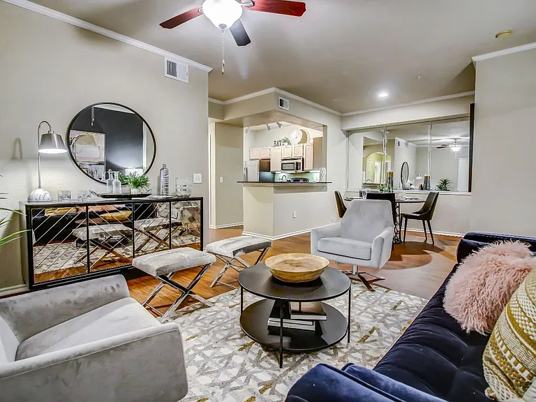Gorgeous living room with hardwood style flooring, crown molding and ceiling fan