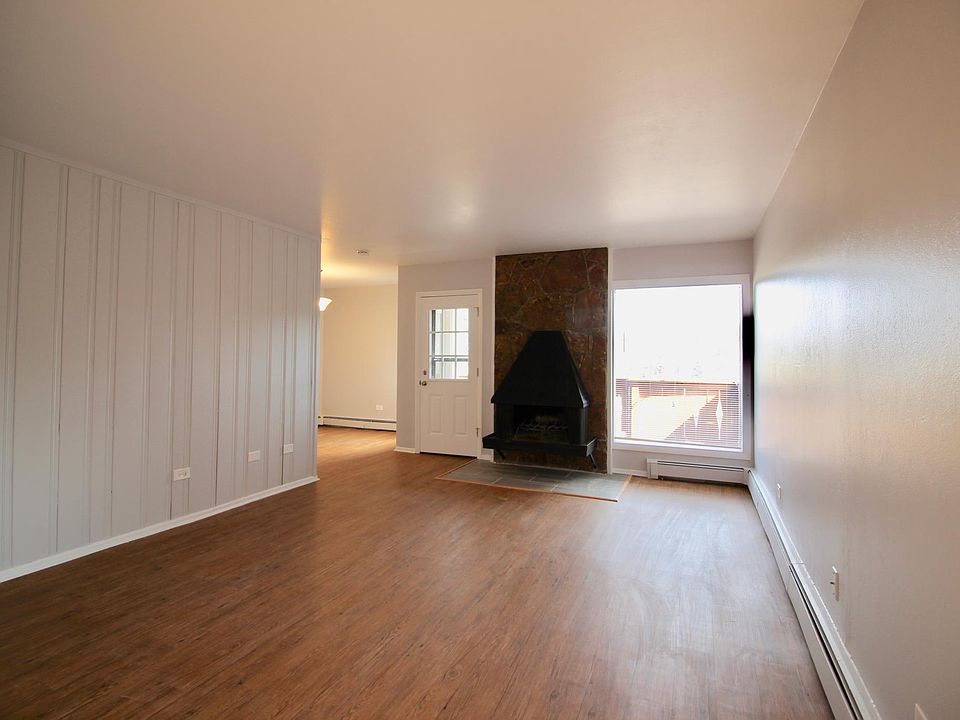 View of main living area and into the dining room from front door. Balcony can be seen thru window.