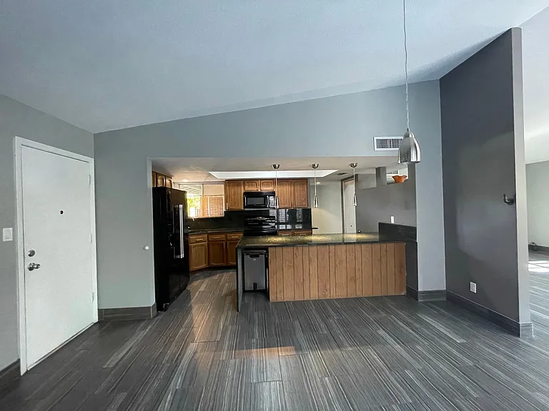 Kitchen is open to living room and wine closet.