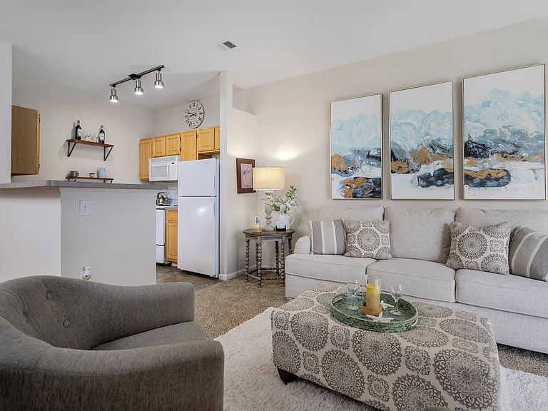 A beautifully designed living room with cozy seating and a sleek coffee table, perfect for relaxing at home.