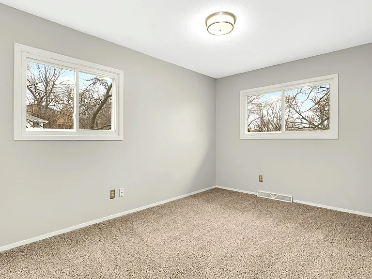 Comfortable primary bedroom with fresh carpet and neutral finishes