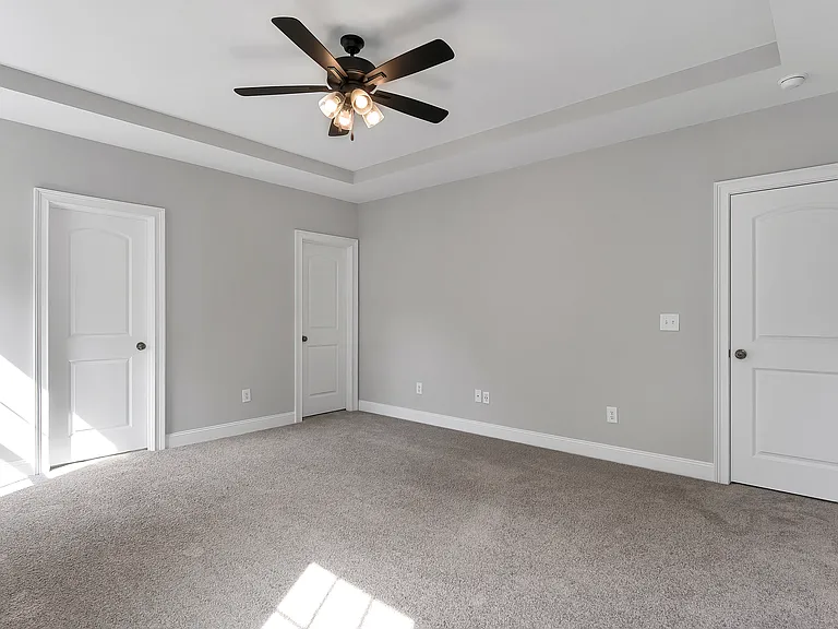 Primary bedroom with closet and bathroom doors