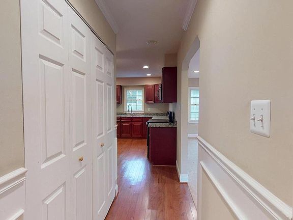 Hall to kitchen with laundry closet