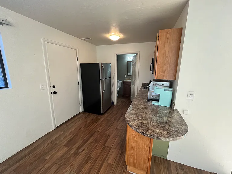 kitchen area, fridge, sink, countertop air fryer/toaster oven, countertop burners, microwave. Does NOT include a full size oven/stove.