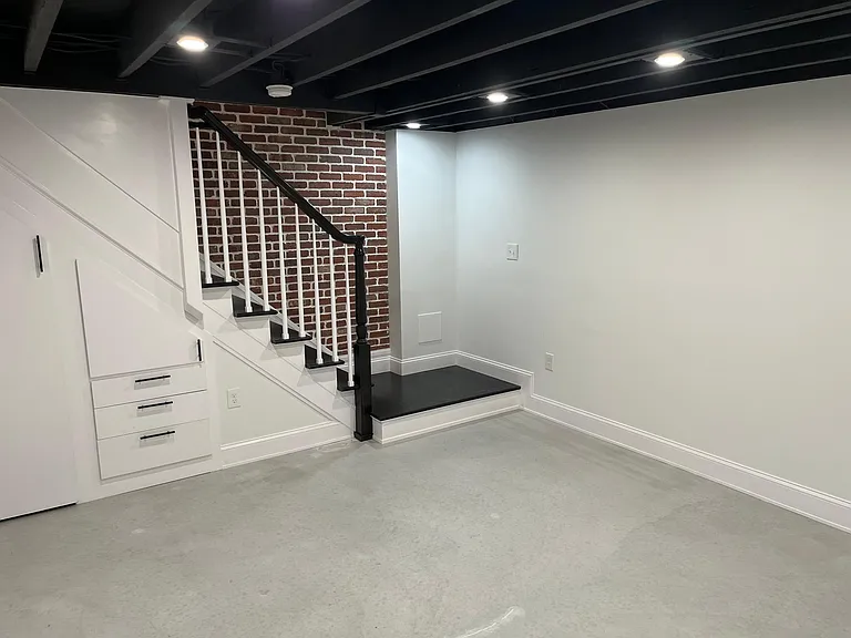 Built in storage under the stairs.