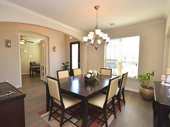 Nice view from the entry from the kitchen to the formal dining, with the large windows over looking the front of the home.