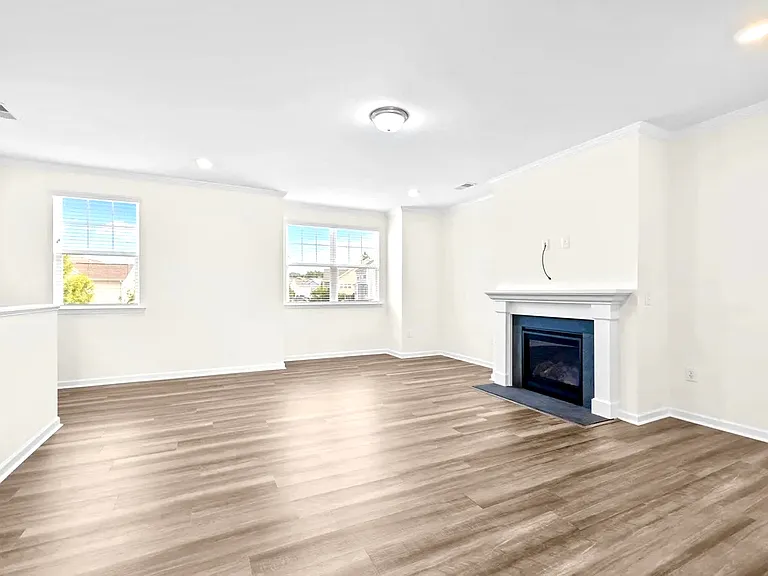 Very large living room with extra area/nook for a desk or extra cabinet. Gas fireplace. Lots of natural light.