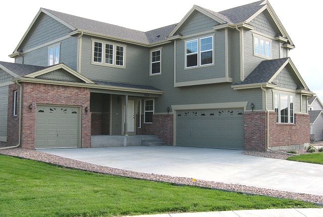 Street view, with a double car garage on the right and the single car garage on the left.