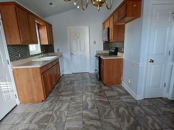 Kitchen. Door in the rear leads to the laundry room. Door to the right is the pantry.