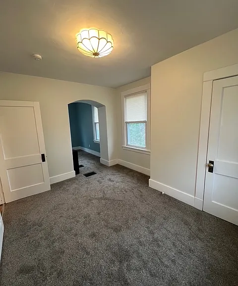 Spacious bedroom/nursery including 2 closets, updated paint and brand new lighting. Laundry chute located in the middle of the bedroom.