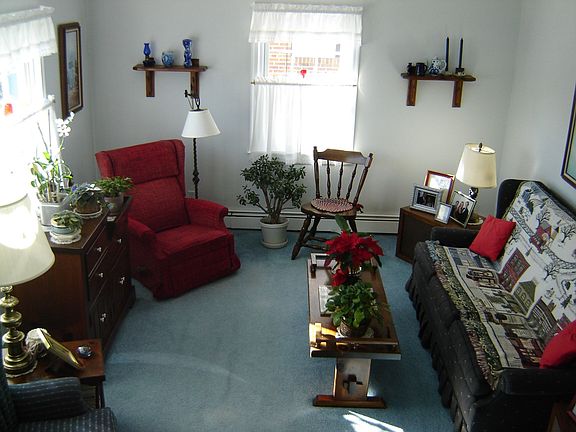 Living room with hardwood floor under carpet