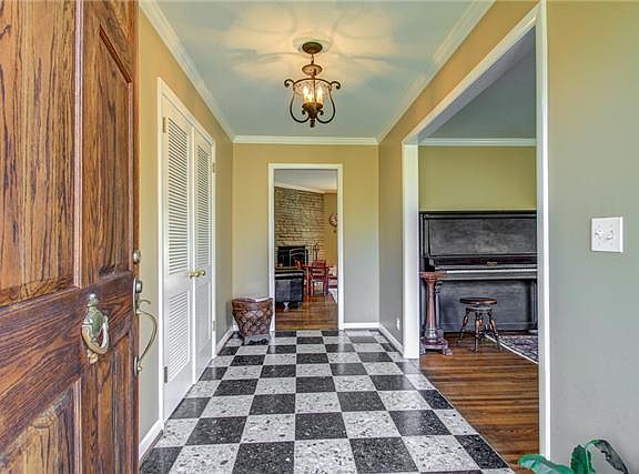 View of entrance hall from front door with large coat closet