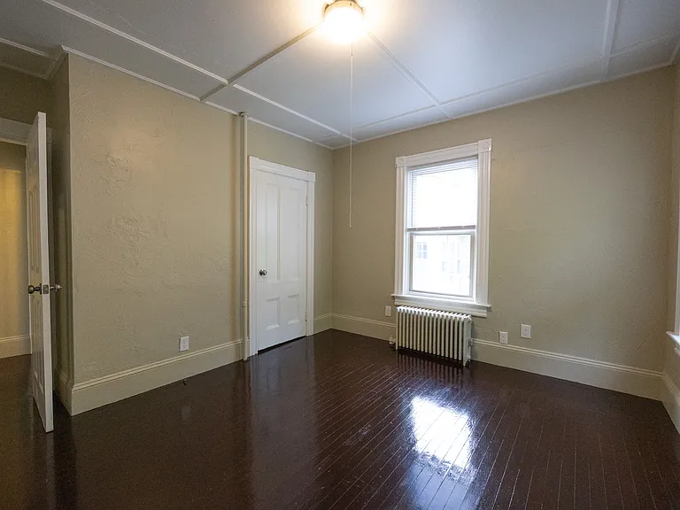 Bedroom with natural light and hardwood floors