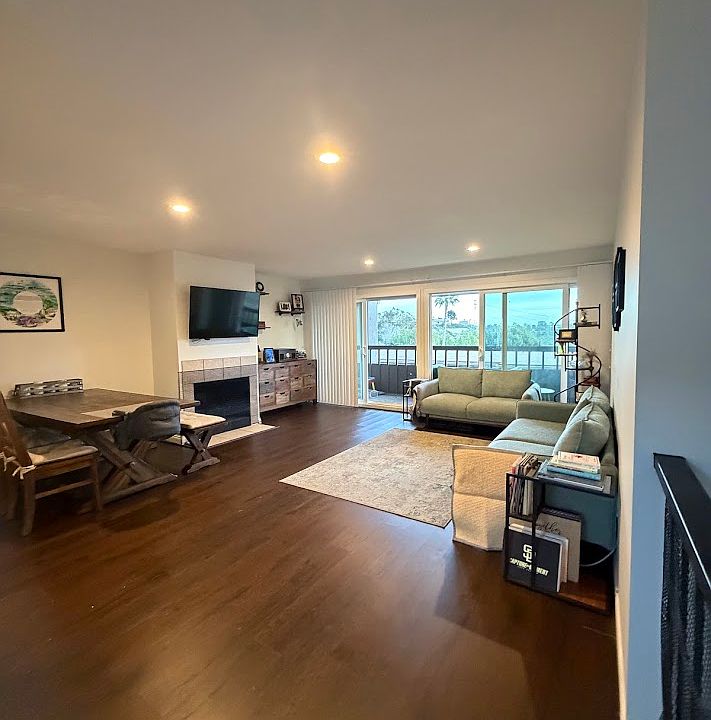 view of living room from front entrance 
balcony visible through glass sliders