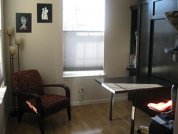 downstairs bedroom with custom wall bed/workspace