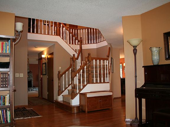 Oak hardwood floors wrap around the central staircase