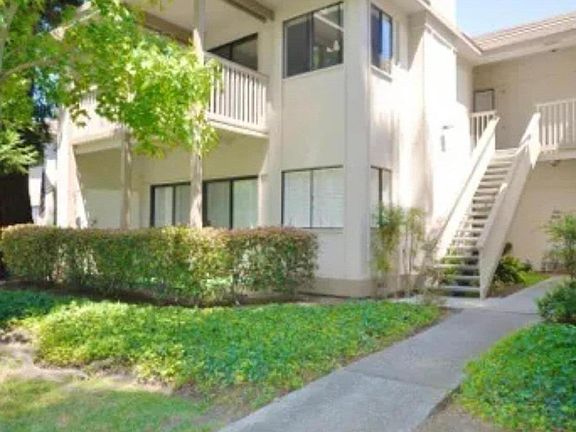 Exterior of #48 on second floor. Great light! Water fountain creates serenity in this quiet condo complex. Club house off of pool for mail and packages. Available for private parties.