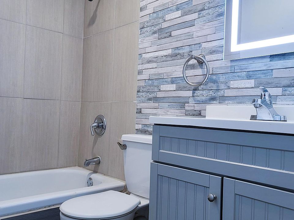 Bathroom with lighted mirror and modern fittings.
