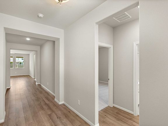 As you enter the home you re greeted by two bedrooms and a glimpse of the open concept living space.