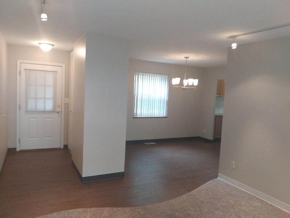 View from living room to dining room, door leads to patio area.