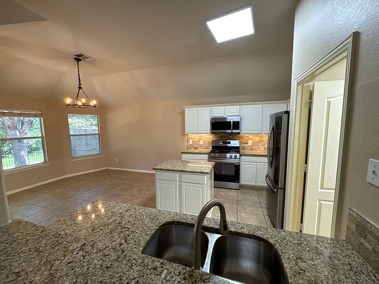 Another view of kitchen and breakfast area
