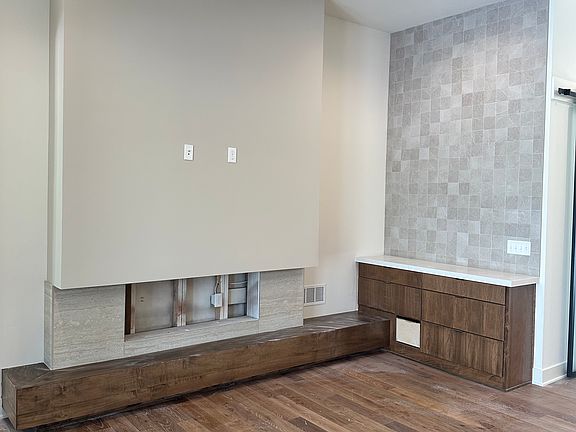 Living room with modern fireplace and custom wet bar