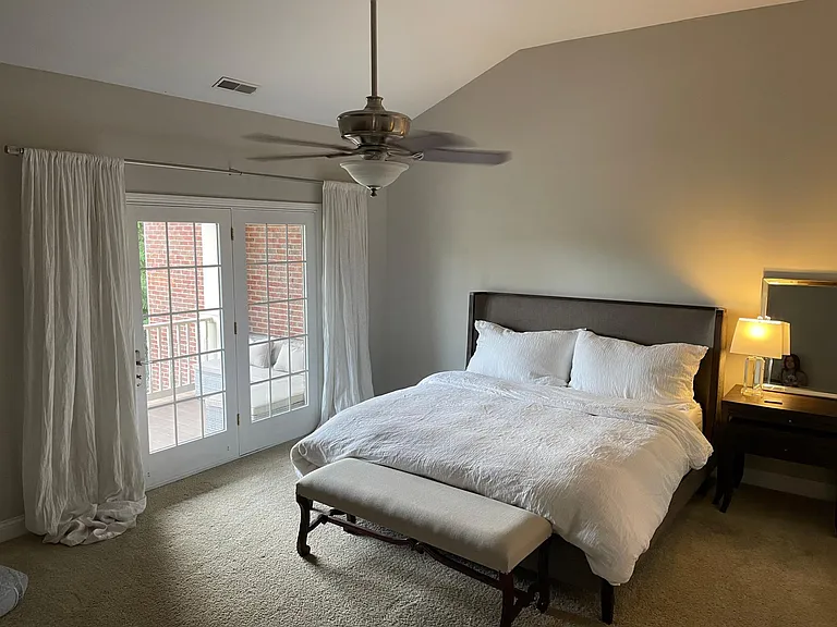 Private primary suite with vaulted ceilings and peaceful retreat-like atmosphere
