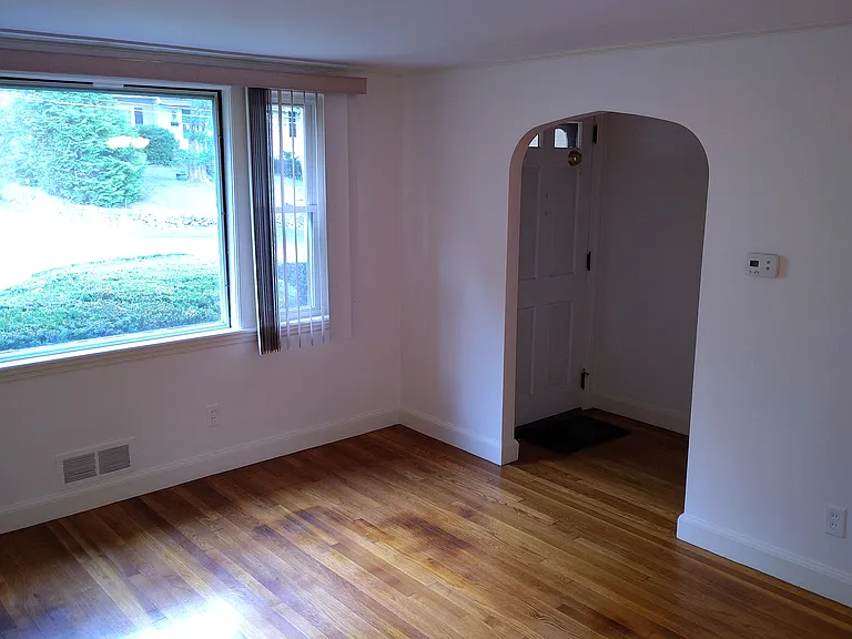 Dining/Living room area taken showing the front window and doorway.